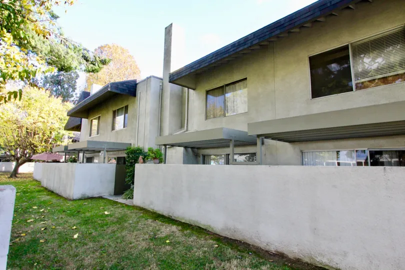 A two-story apartment complex with exterior walled-fences at Bixby Green, in Garden Grove, California.