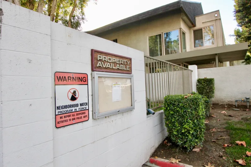 THE HOUSE IN THE BIXBY GREEN WITH THE WARNING BOARD, PLANTS, TREES