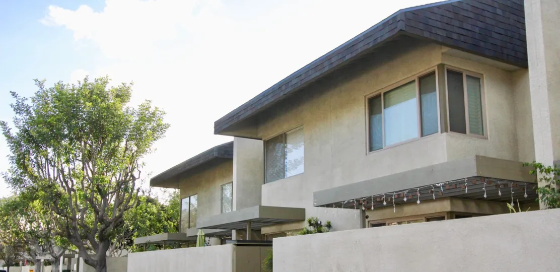 THIS SHOWS THE FRONT OF THE HOME WHICH HAVE THE TREES NEARBY PLANTED, GLASS WINDOWS, ARE LOCATED IN THE COMMUNITY OF BIXBY GREEN