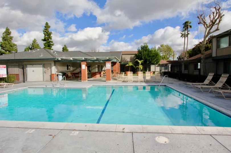 clear pool decorated with chairs inside the compound in Brookdale