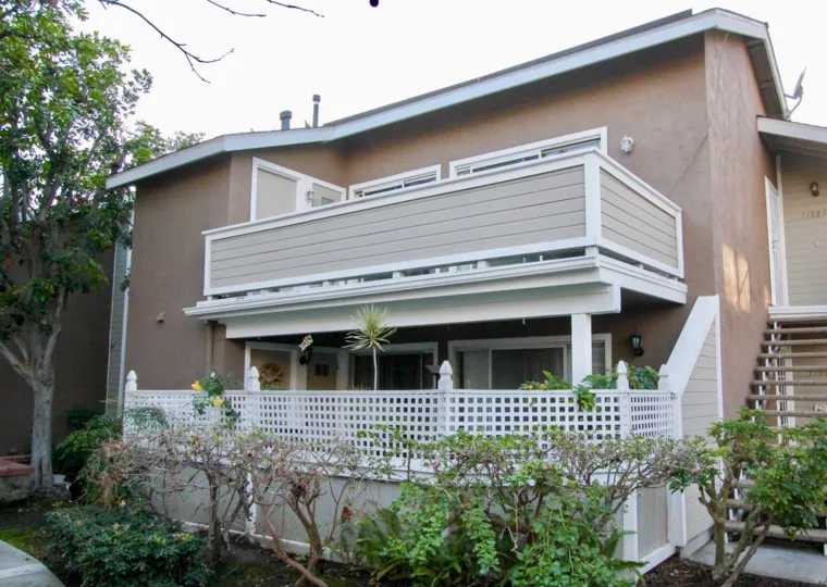 THE BUILDING IN THE BROOKHAVEN CIRCLE WITH THE UPSTAIRS, PLANTS, TREES, DISH ANTENNA
