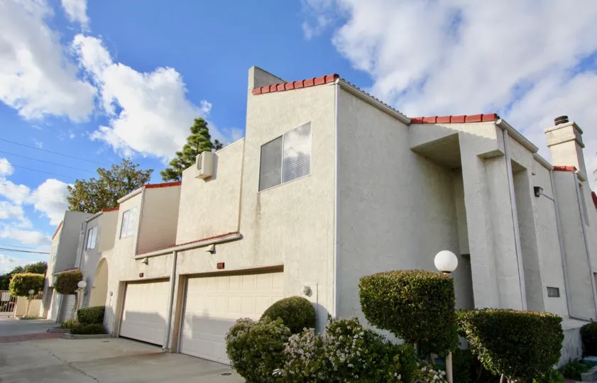 Dramatic Spanish Style Architecture with graceful shrubbery at Casa Loma Village in Garden Grove, CA
