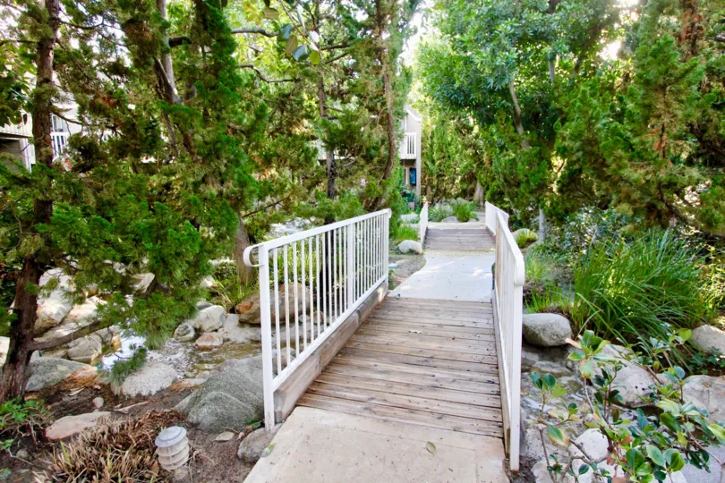THE FLAT IN THE COBBLESTONE CREEK WITH BRIDGE, STONES, WATER, PLANTS, TREES