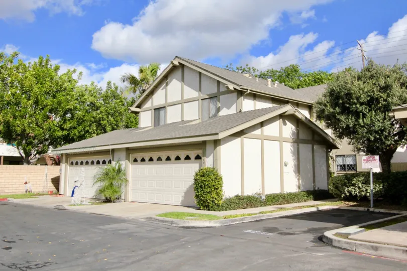 THIS PICTURE SHOWS THE SMALL HOUSE WITH THE EMPTY PLACE WHICH HAVE THE TREES, PLANTS AND THE PATHWAY TO GO OUTSIDE IS IN THE CITY OF GARDEN GROVE