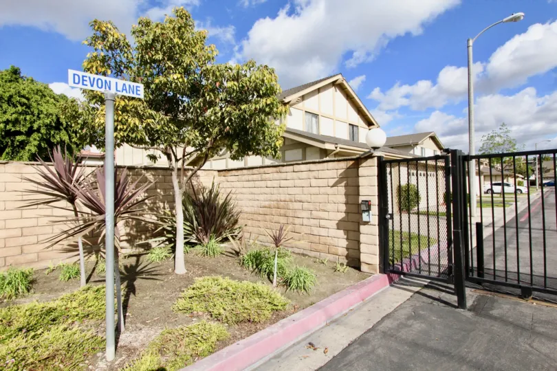 THE HOUSE IN THE DEVONSHIRE VILLAGE WITH THE CAR PARKING, GATE, STREET LIGHT