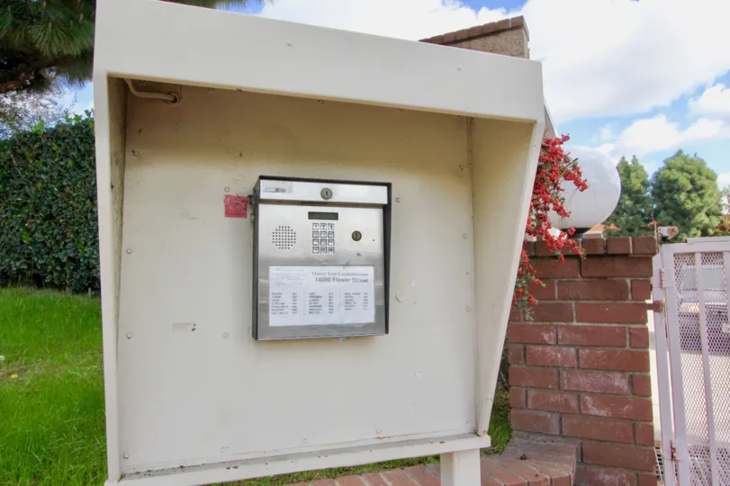 THE HOUSE IN THE FLOWER TREE WITH THE ELECTRIC BOX, LAWN, PLANTS, TREES
