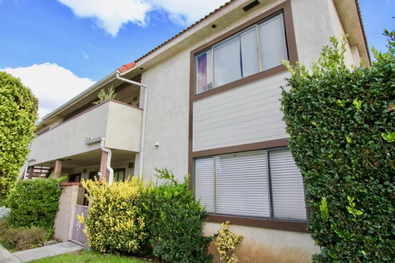 Side view on a sunny day of a two story home in the Flower Tree Community of Garden Grove, California