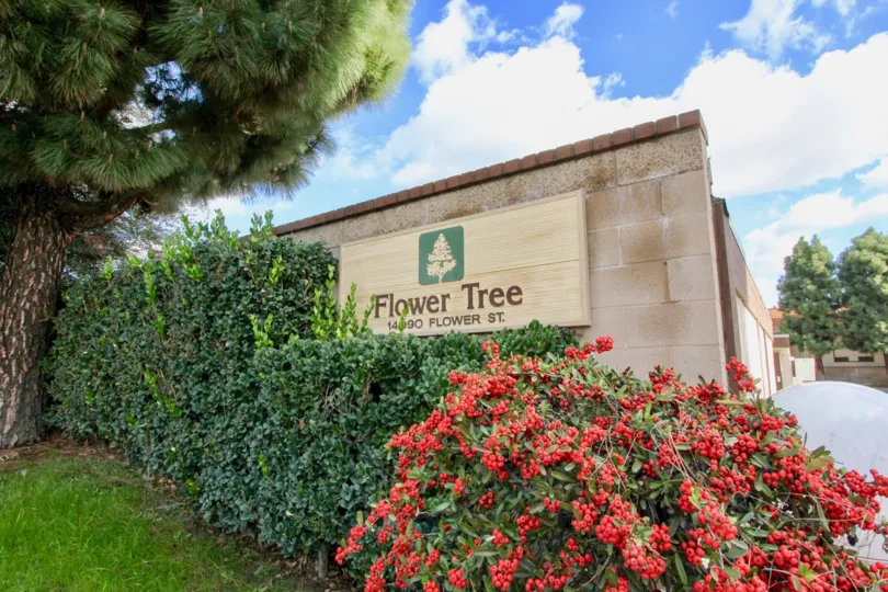 THE FLAT IN THE FLOWER TREE WITH THE FLOWR TREE NAME WALL, LAWN, PLANTS, TREES
