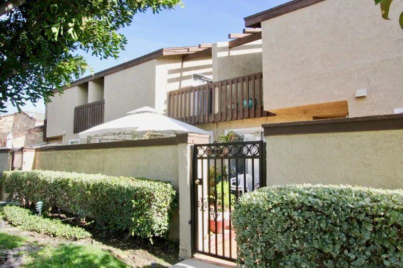 THE FRONT VIEW OF HOUSE WHICH IS LOCATED IN GARDEN GROVE, AND SHOWS MANY PLANTS, TREES