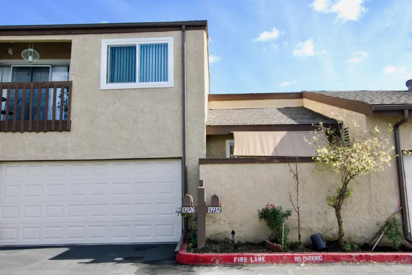 Back side view of the building having trees and plants near to the building in Garden Terrace Townhomes