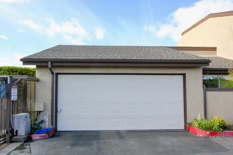 clean and clear area view in front garage near house having trees and plants around in Garden Terrace Townhomes