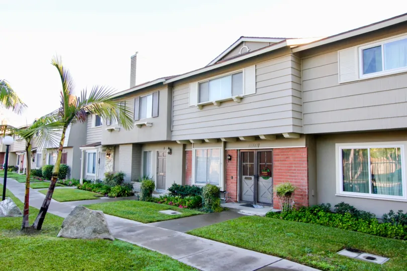 Grey two story town homes with sidewalk in Garden Grove, CA