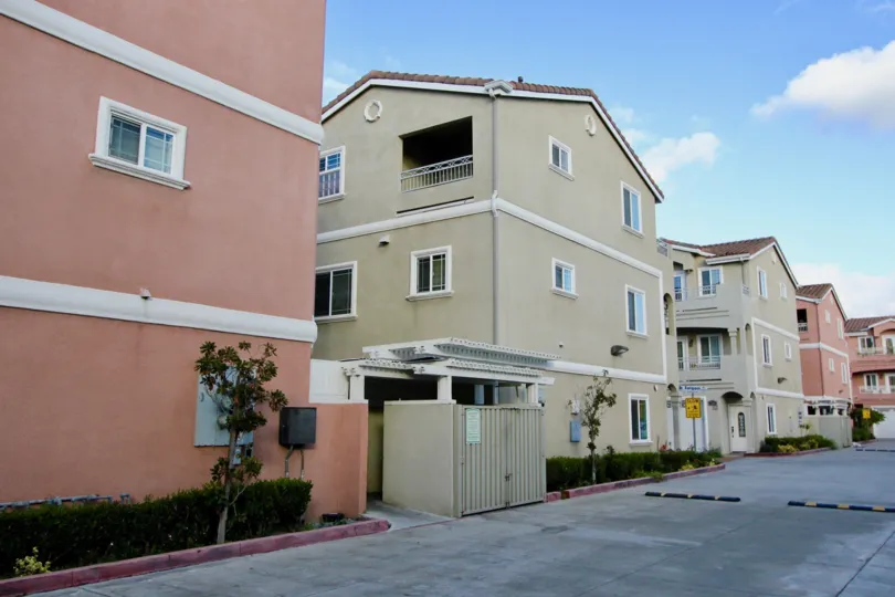 A large residential complex inside the Golden village community with a big drive way
