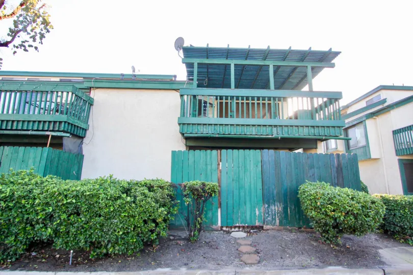 The Greenhouse West in the Garden Grove with a house and bushes