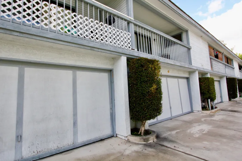 garage front view of the building decorate with plants in Hewitt Place Townhomes