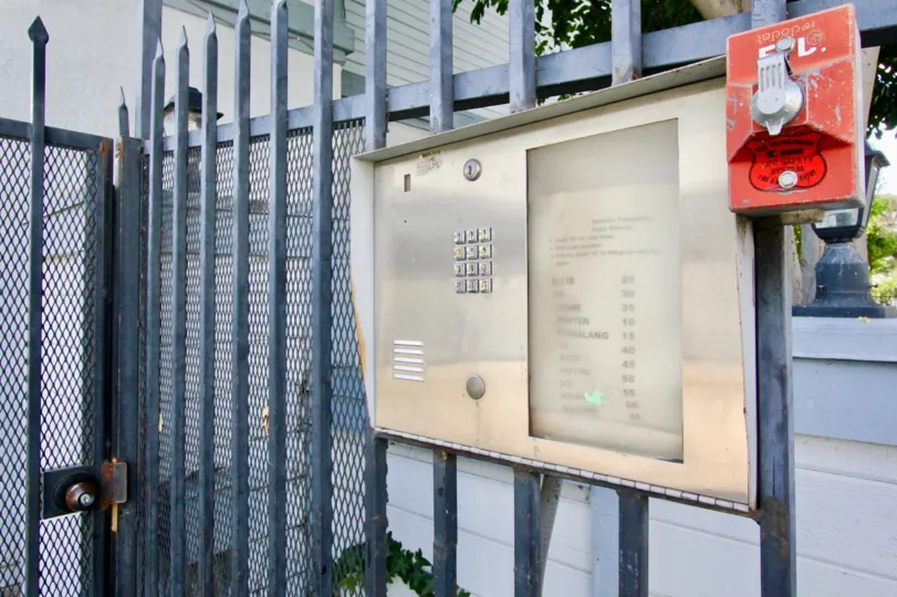 A security gate in Hewitt Place Townhomes with a keypad and intercom.