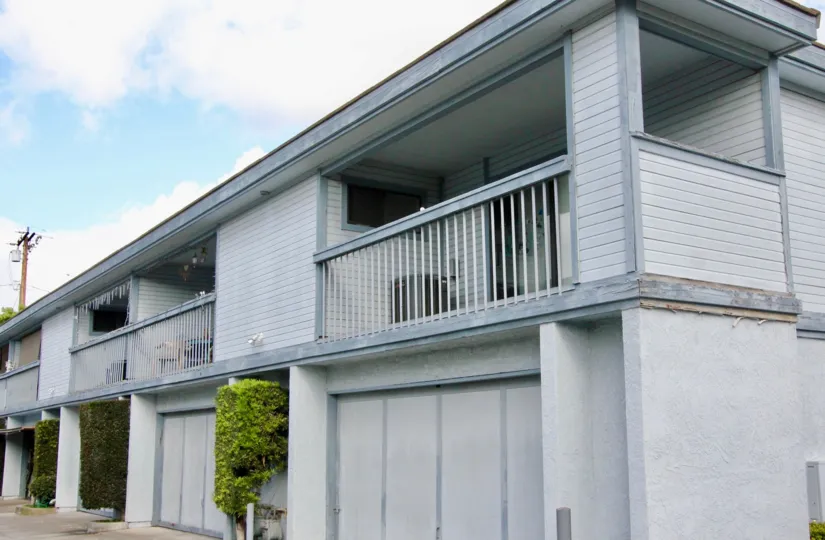 THE HOUSE IN THE HEWITT PLACE TOWNHOMES WITH THE BALCONIS, TREES, PLANTS