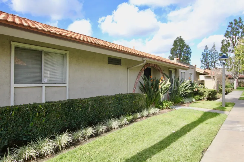Neatly trimmed hedges and manicures lawn on a sunny day at La Jolla Plaza in Garden Grove, CA