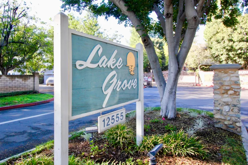 THE 12555 APARTMENT IN THE LAKE GROVE WITH THE LAKE GROVE BOARD, PLANTS, TREES