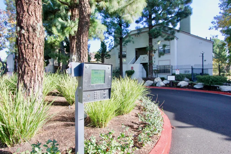 THE BUILDING IN THE LAKESIDE WITH THE ELECTRICBOX, ROCKS, TREES, PLANTS