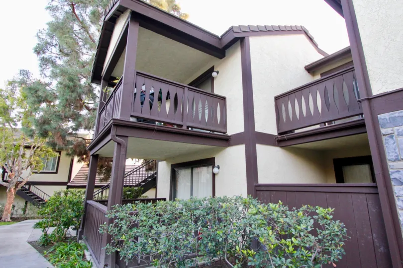 Two story condo buildings with enclosed patios at Lez Jardins in Garden Grove CA