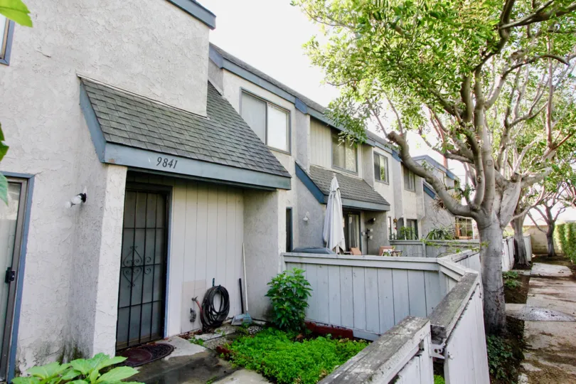 THIS IS THE SIDE VIEW OF THE VILLAS THAT HAS THE INDIVIDUAL NUMBERS ON THE WALLS, PLANTS AND TREES ARE SHOWN IN THE COMMUNITY OF LIVINGSTON MEADOWS