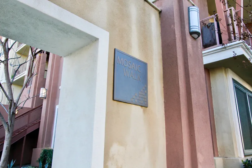 A pleasant day in the community of Lotus Walk featuring a Mosaic Walk plaque near the residences