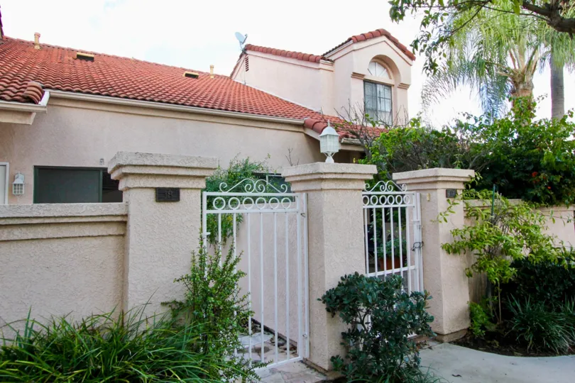front entrance view of the building decorated with plants and flowers in Martinique Gardens