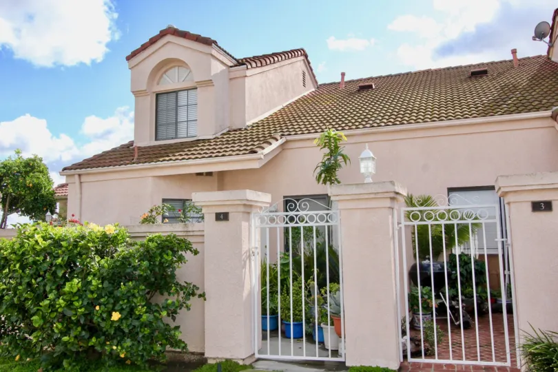 THIS IMAGE REPRESENTS THE FRONTVIEW OF THE HOME AND SHOWS THE BEAUTIFUL PLANTS AND TREES, DISH ON THE TOP WHERE IS LOCATED IN THE COMMUNITY OF MARTINIQUE GARDENS