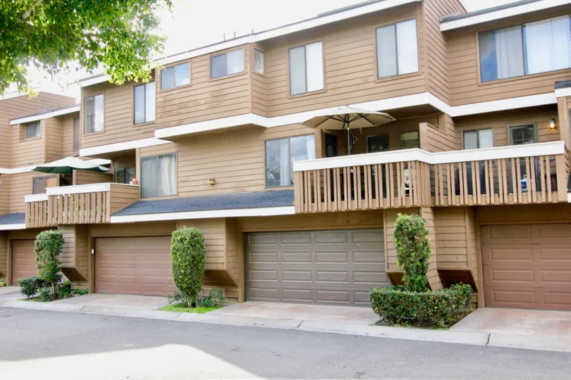 A large house with a multiple garage doors inside Meadow brook village community
