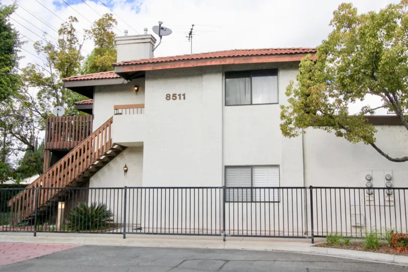 compound gate view of the building no 8511 having trees and plants around in Meadow Brook Village