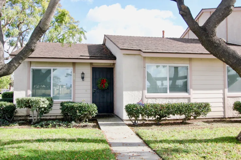 THE CUTE HOUSE IN THE NEW BROOKDALE WITH THE LAWN, TREES, PLANTS