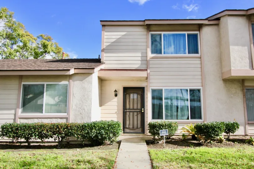 THE HOUSE WITH GLASS WINDOWS, LAWN, SMALL PLANTS ARE THERE IN THE CITY OF GARDEN GROVE