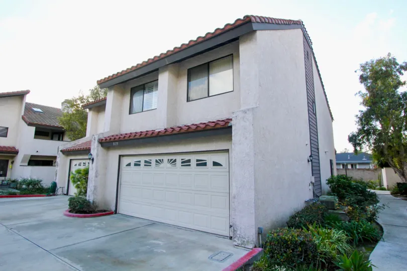 THE HOUSE IN THE PEPPERTREE TOWNHOMES WITH THE SHUTTER, PLANTS, TREES