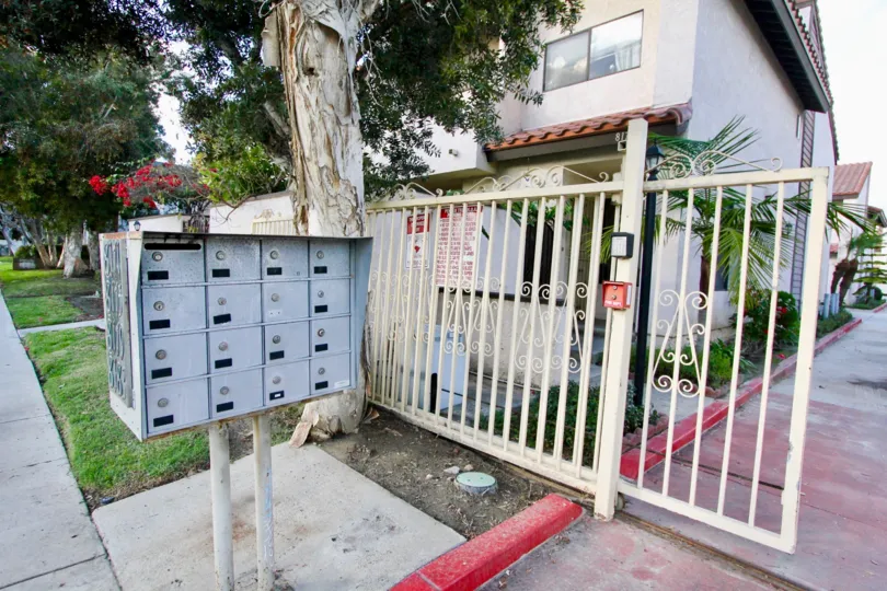 THE FLAT IN THE PEPPERTREE TOWNHOMES WITH THE LAWN, GATE, FLOWER PLANTS