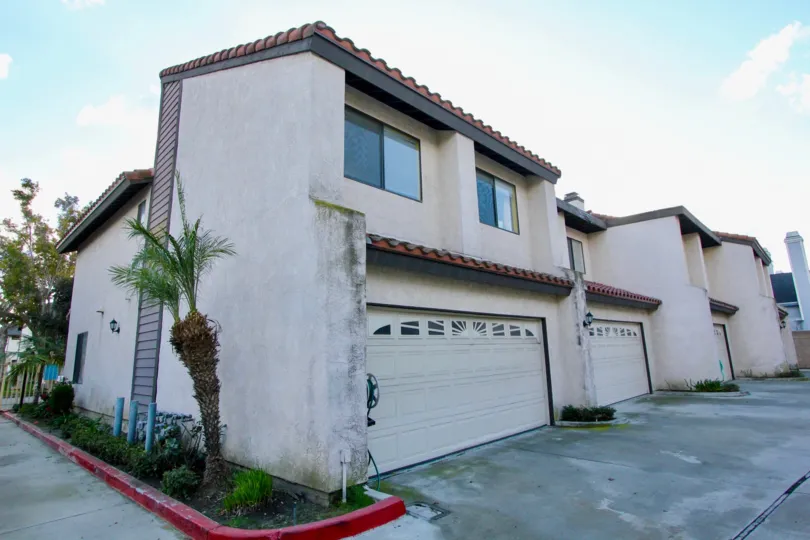 House at the Peppertree Townhomes in Garden Grove with little tree and road