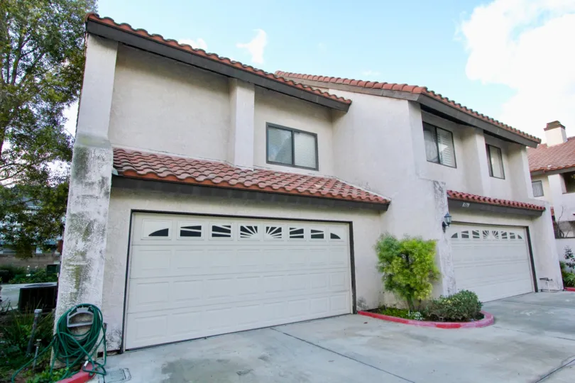A large house with red slope tiled roofs in the peppertree townhomes community