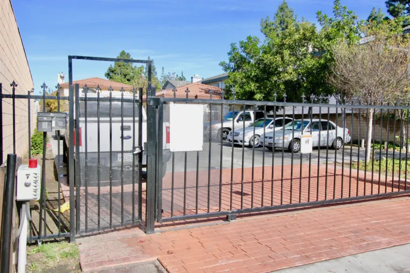 A gated parking lot with a handful of spaces for homeowners in the Pine Villas neighborhood of Garden Grove, California.
