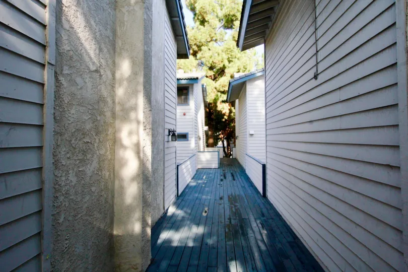 clean and clear wooden alley between buildings in Pine Villas