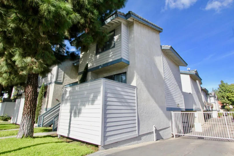 THE FLAT IN THE PINE VILLAS WITH THE GATE, LAWN, TREES, PLANTS