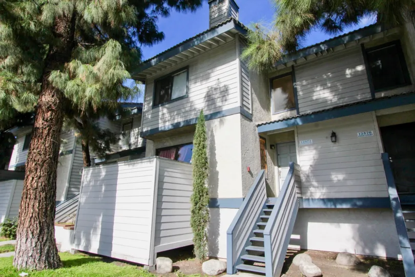 The Pine Villas in the Garden Grove with a beautiful house and trees