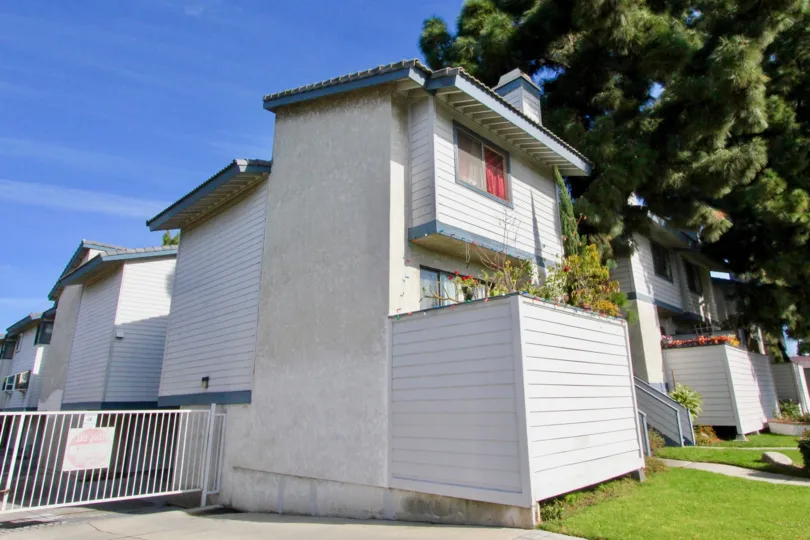 A small house and an adjacent gated are in the neighborhood of Pine Villas in Garden Grove, California.
