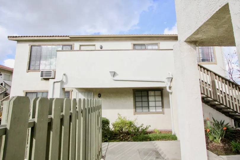 THIS VIEWS THE SIDE VIEW OF THE HOUSE WHICH HAS THE PLANTS UNDER THE STEPS AND AROUND THE WALLS LOCATED IN THE COMMUNITY OF SPRING GARDEN VILLAS