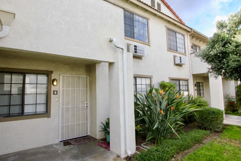 THIS IMAGE VIEWS THE SIDE VIEW OF VILLAS THAT HAS THE BEAUTIFUL LAWN, PLANTS, TREES ARE LOCATED IN THE CITY OF GARDEN GROVE
