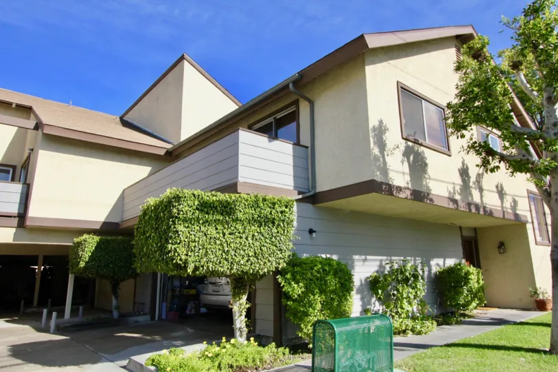 A condo with overhang and balcony on a sunny day in Stanford Plaza in Garden Grove, California.