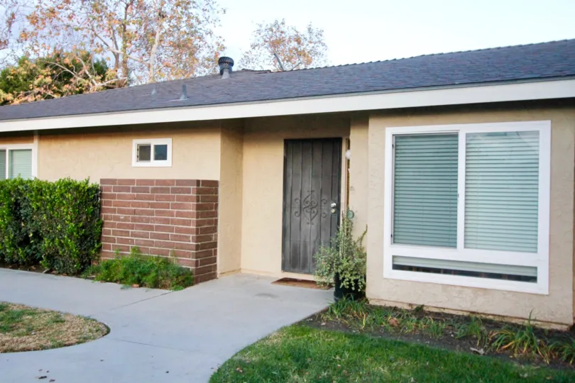 Stonegate home house in front of small park in Garden Grove