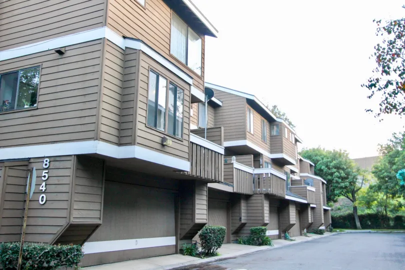 THE APARTMENT WITH TREES, PLANTS, NUMBER ON THE WALL WHICH IS LOCATED IN THE CITY OF GARDEN GROVE