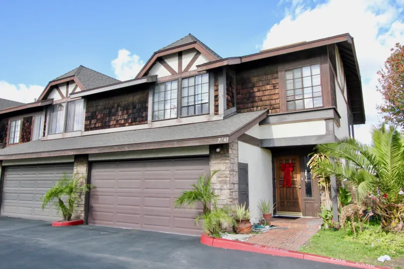 THE 9741 APARTMENT IN THE TUDOR ESTATES WITH THE PLANTS, SHUTTER, TREES