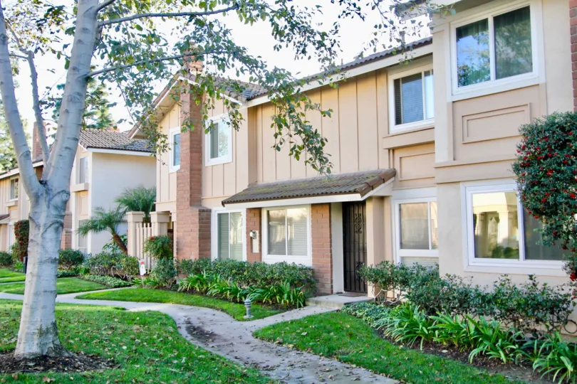 THE HOME IN THE VALLEY VIEW PARK WITH THE PATHWAY, TREES, FLOWER PLANTS