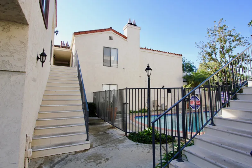 A stairway leading up into a condominium near a swimming pool inside Villa Grande in Garden Grove California